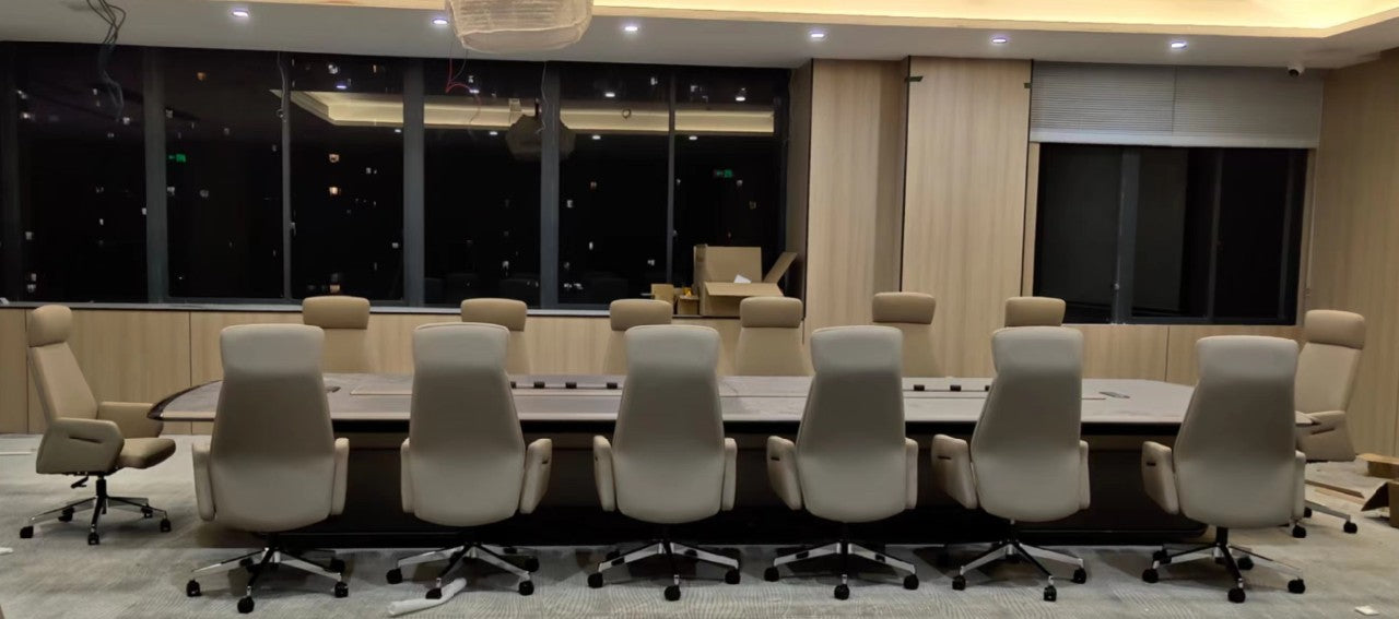 Modern conference room with a long table and multiple chairs.